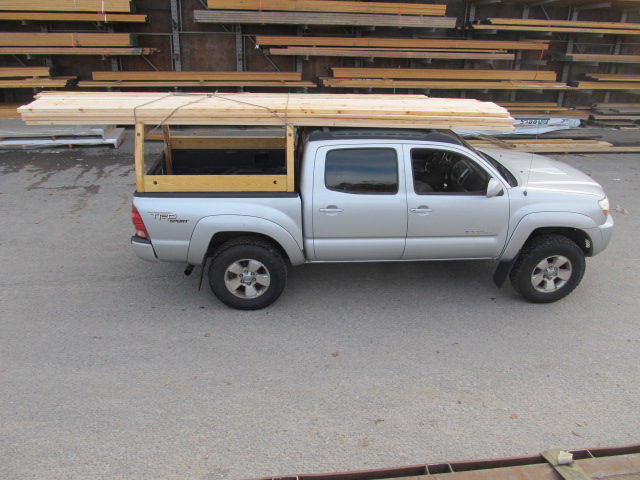 Custom wooden truck rack on a silver Toyota