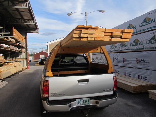 Custom wooden truck rack on a silver Toyota
