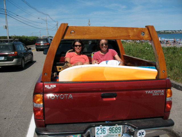 Red Toyota truck with custom wooden rack