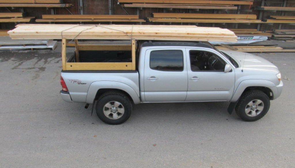 Custom wooden truck rack on a silver Toyota