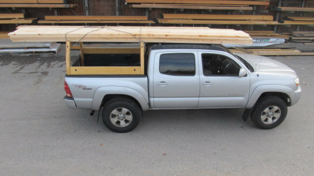 Curstom truck rack with lumber on it.